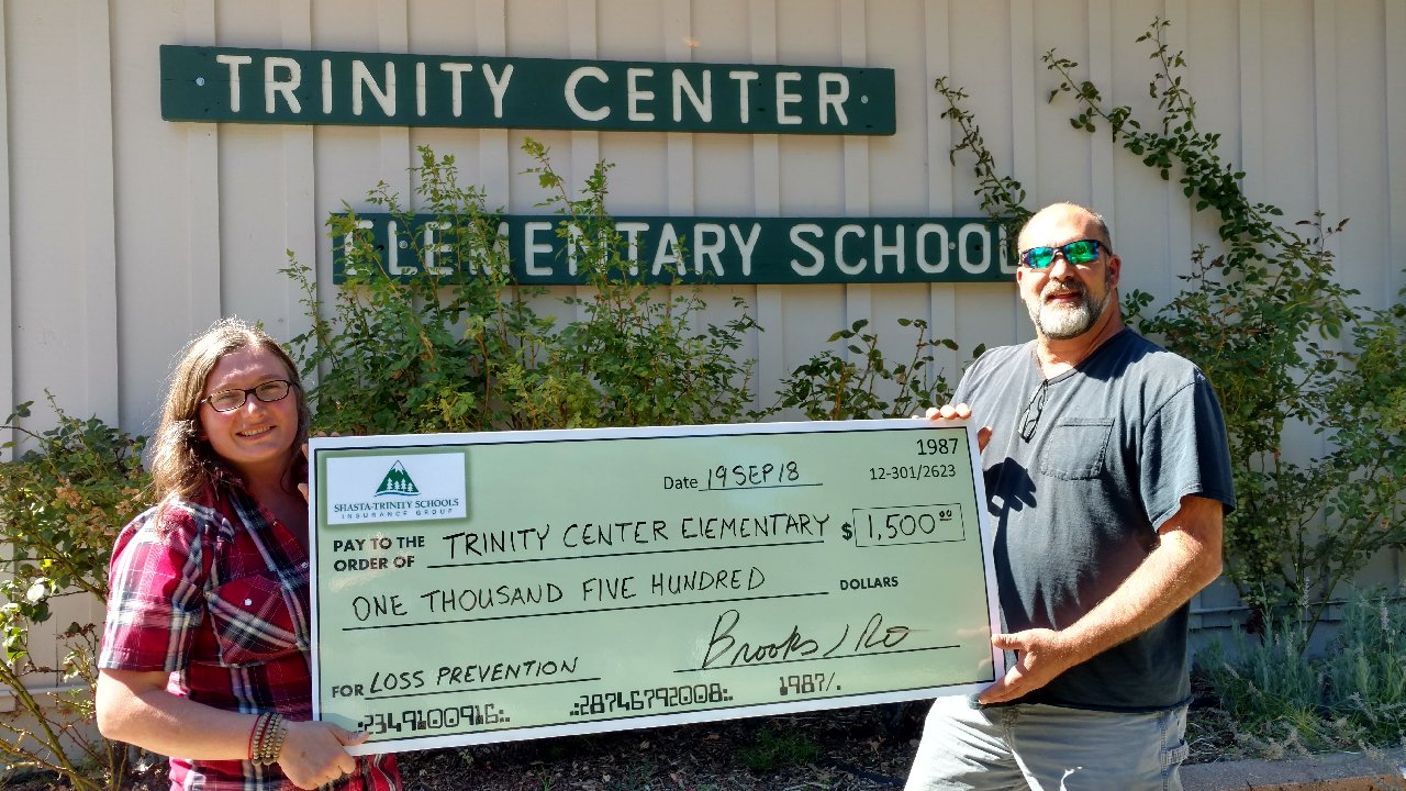 Employees of Trinity Center Elementary with large check